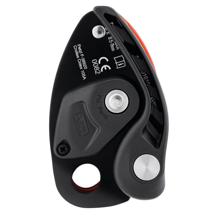 Image shows the front side of the Petzl Neox, colour: black and orange, image also shows the lowering lever