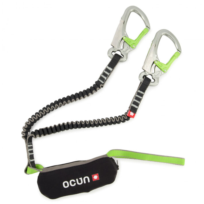 The Ocun Via Verrata Captur - the carabiners are metallic with green gates. The elastic lines are black and grey, with a black shock absorber. The Ocun logo is on the shock absorber.